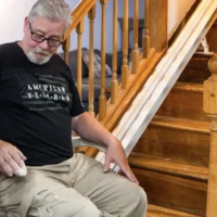US veteran operating his in-home straight stair lift.