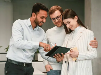 three people reviewing a document