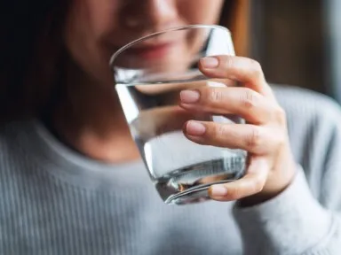 Woman holding a glass of water