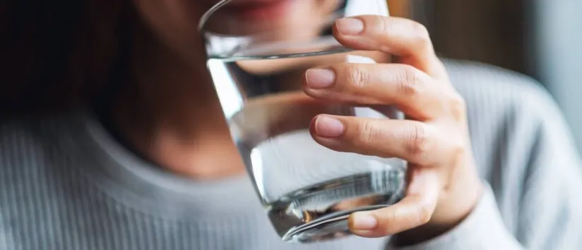Woman holding a glass of water