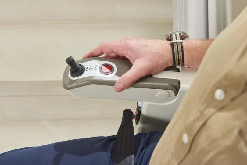 Hand on stairlift control panel