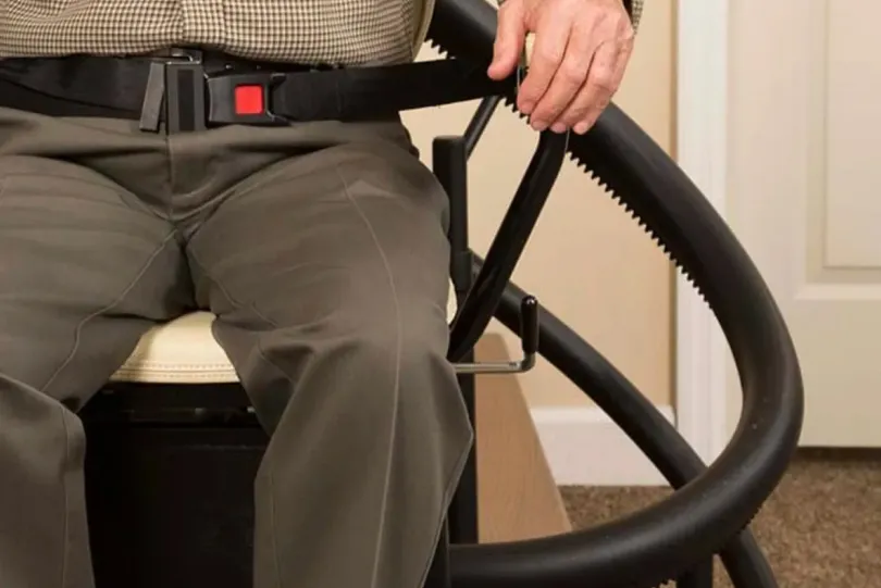 Person using a stair lift seat.