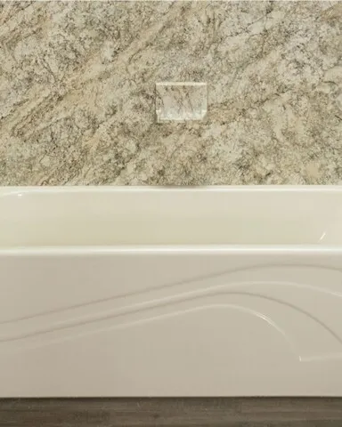 Bathtub with stone walls and black fixtures