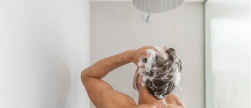 back of man washing hair during bath and shower routine better water