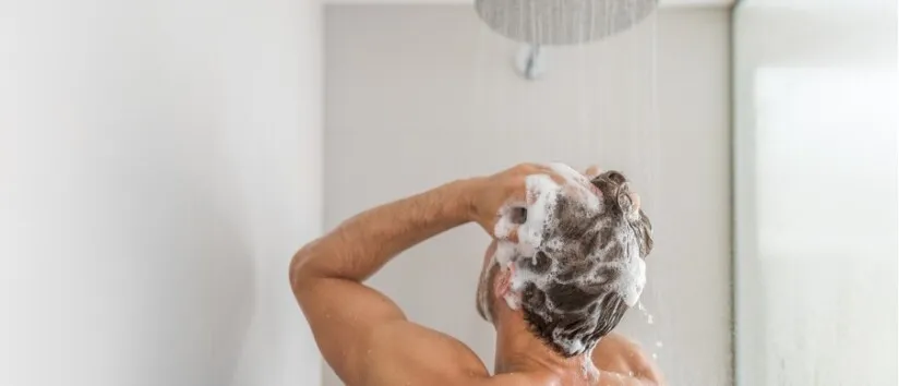 back of man washing hair during bath and shower routine better water