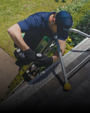 Gutter guards being installed on a home roof