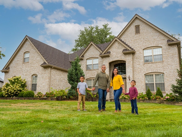 Happy family in front of home
