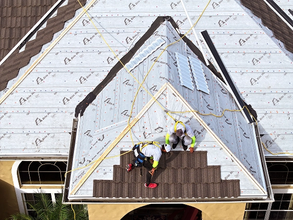 Workers on home rooftop