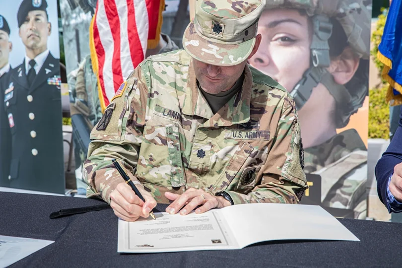 U.S. Army veteran signing a document