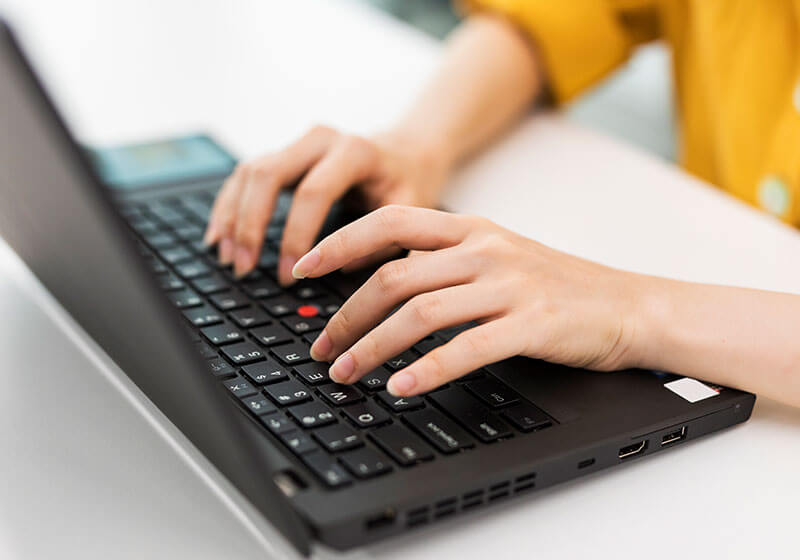woman typing on black laptop computer