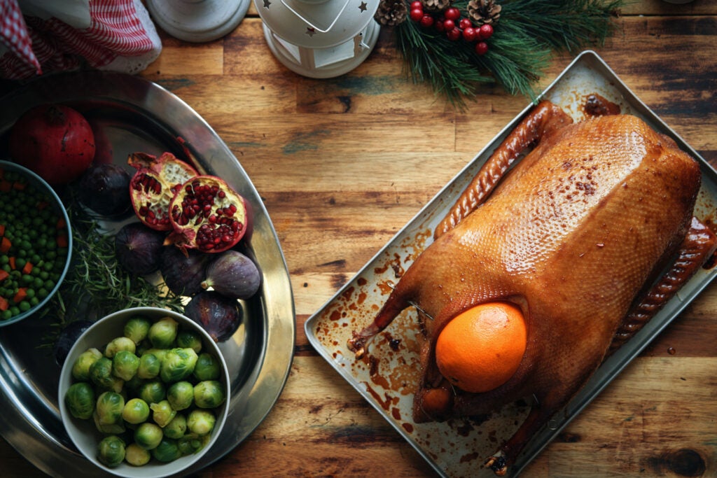 Stuffed Holiday Goose with Fruit and Vegetables on table