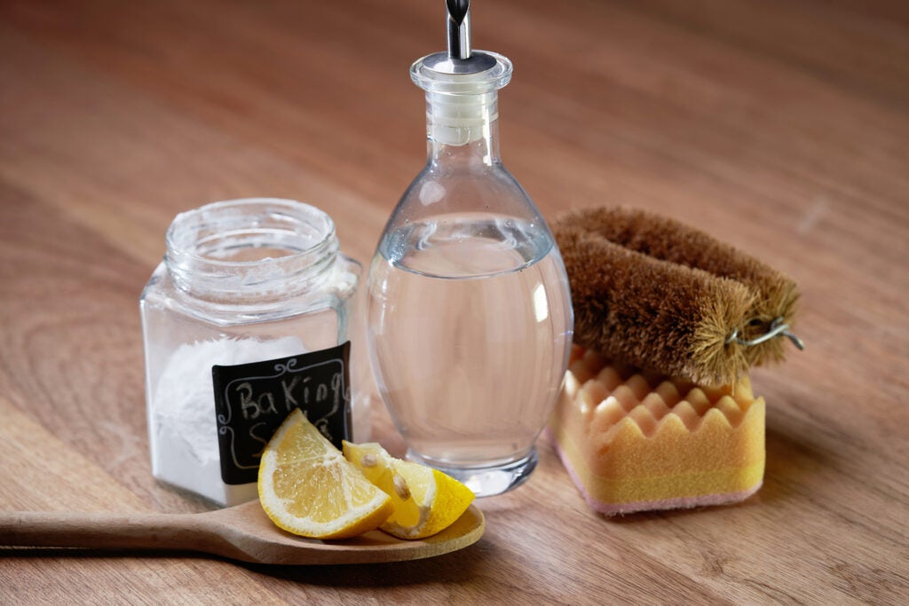 vinegar baking soda and lemon on wood table top to clean hard water stains